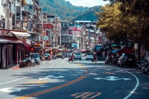 Vibrant urban street scene with shops, vehicles, and mountains in an Asian city. — 5 Steps to Securely Obtain TRT Through Tel