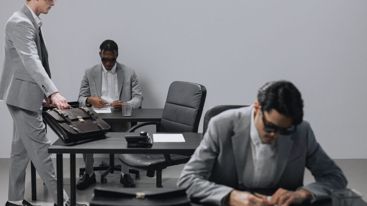 Business office with diverse employees in gray suits working at desks in an indoor setting. — Boost Your Agency's Growth with