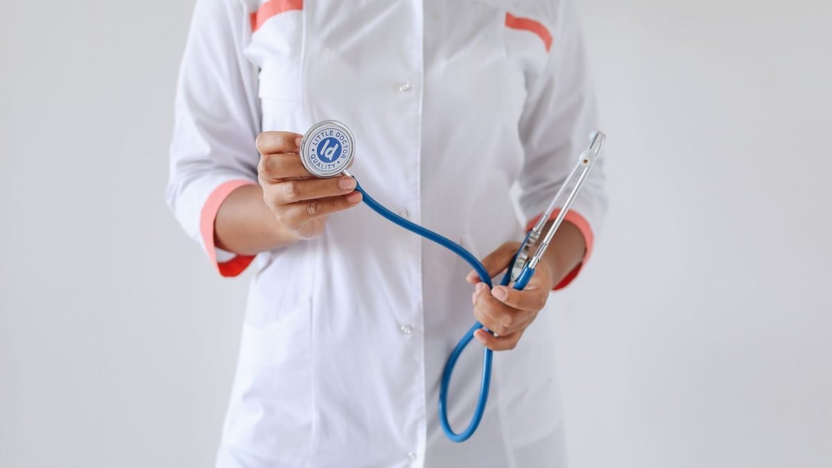 Close-up of a female doctor holding a blue stethoscope, emphasizing healthcare and professionalism. — Driving Progress in Pat