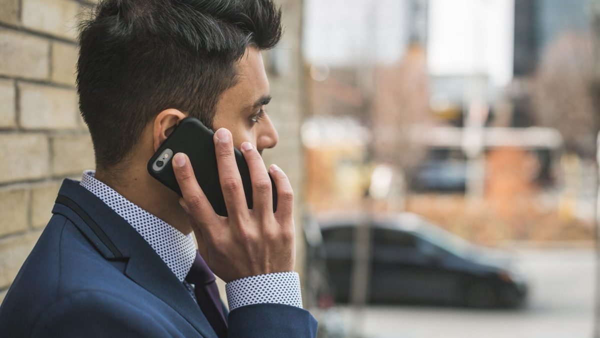 Professional man in suit making a phone call outside in city setting. — Explore the Best Window Options in Doral, FL