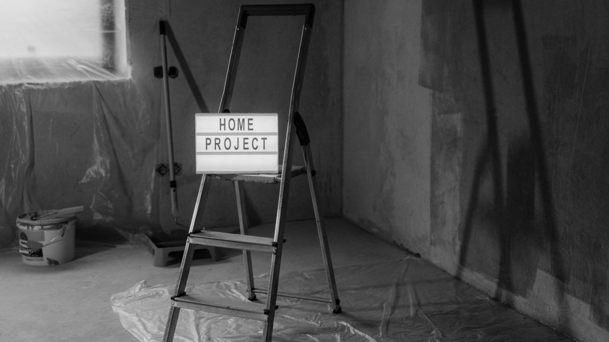 Black and white image of a step ladder with a 'home project' sign in a renovation setting. — "Get Top-Tier Window Replacement