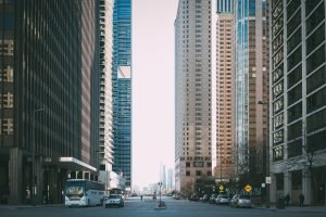 Vibrant city street scene with tall skyscrapers and city life full of cars and pedestrians. — Rapid Results: How to Sell Your