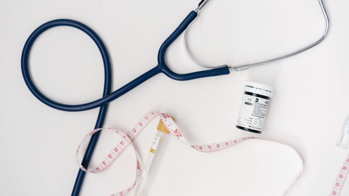 Flat lay of medical tools including stethoscope and measuring tape on a white background. — Strategic Growth and Healthcare E