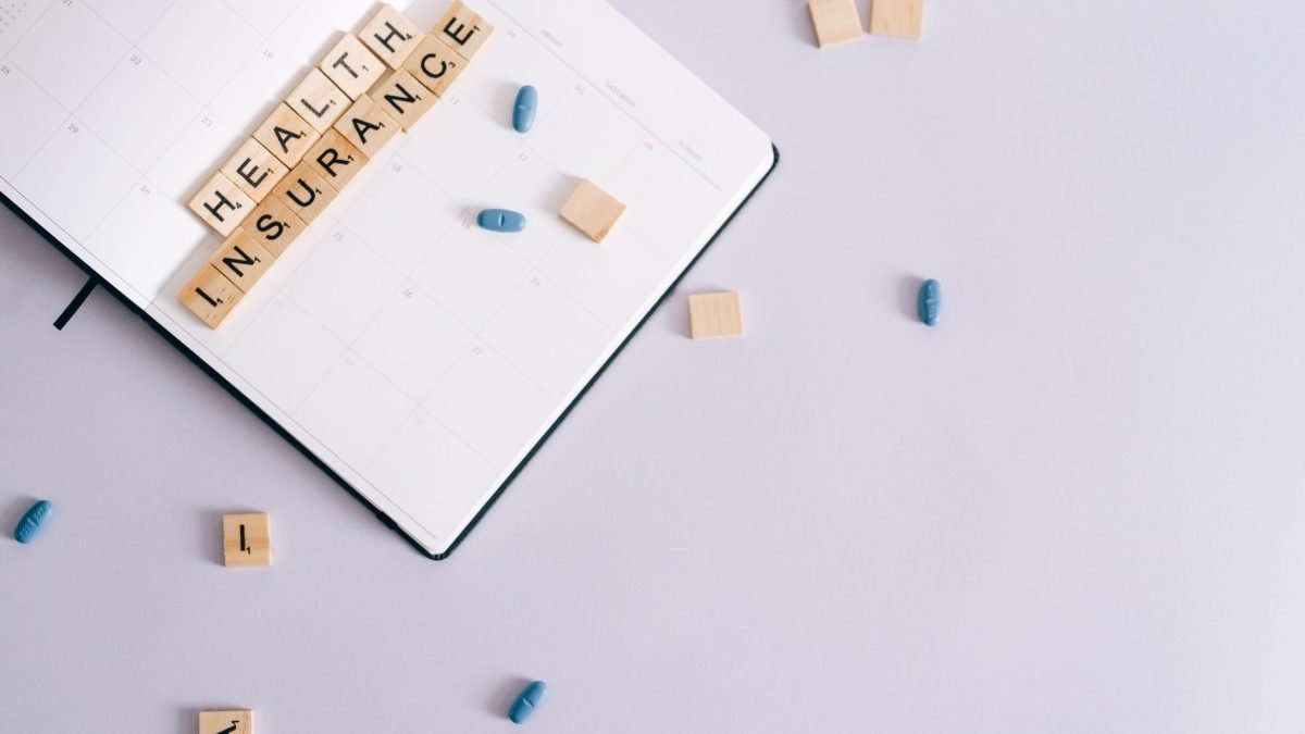 Flat lay of health insurance concept with planner and pills. — UNT Health Fort Worth Moves Forward with Unified Branding