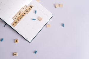 Flat lay of health insurance concept with planner and pills. — UNT Health Fort Worth Moves Forward with Unified Branding